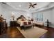 Elegant main bedroom features wood flooring, tray ceiling, sitting area, and plantation shutters at 11014 Hawkshead Ct, Windermere, FL 34786