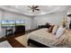 Spacious main bedroom with hardwood floors, custom drapes, tray ceiling, and access to balcony at 11014 Hawkshead Ct, Windermere, FL 34786