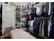 Walk-in closet with custom shelving, cabinets and wooden floors at 11014 Hawkshead Ct, Windermere, FL 34786