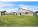 Spacious backyard enclosed by a wood fence, perfect for outdoor enjoyment and privacy at 117 Honeywood Dr, Kissimmee, FL 34743