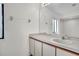 Bright bathroom with a white vanity, mirror, and a window providing natural light at 117 Honeywood Dr, Kissimmee, FL 34743