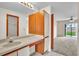 Brightly lit bathroom with a large vanity and a door leading to the bedroom at 117 Honeywood Dr, Kissimmee, FL 34743