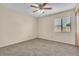 Neutral bedroom with carpet, ceiling fan and window bringing in lots of natural light at 117 Honeywood Dr, Kissimmee, FL 34743