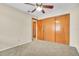 Bedroom includes double closet, neutral walls, carpet, and ceiling fan at 117 Honeywood Dr, Kissimmee, FL 34743