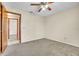 Neutral bedroom with carpet, ceiling fan and view into hall and front bedroom at 117 Honeywood Dr, Kissimmee, FL 34743