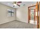 Bedroom with a window, neutral colored walls, carpeted floor and wood trim door at 117 Honeywood Dr, Kissimmee, FL 34743