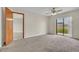 Carpeted bedroom with backyard access and great natural lighting at 117 Honeywood Dr, Kissimmee, FL 34743