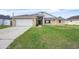 Inviting single-Gathering home boasts a two-car garage and a well-maintained lawn at 117 Honeywood Dr, Kissimmee, FL 34743