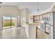 A modern kitchen features stainless steel appliances, lots of cabinet space, and an eat-in bar area at 117 Honeywood Dr, Kissimmee, FL 34743