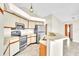 A modern kitchen featuring stainless steel appliances, lots of cabinet space, and an eat-in bar area at 117 Honeywood Dr, Kissimmee, FL 34743