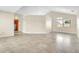 Spacious living room with tile floors, a vaulted ceiling, and a large window at 117 Honeywood Dr, Kissimmee, FL 34743