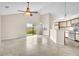 Open-concept living room with tile flooring, high ceilings, and natural light streaming through sliding glass doors at 117 Honeywood Dr, Kissimmee, FL 34743