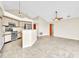 An open living room and kitchen area featuring tile floors, pendant lighting, and stainless appliances at 117 Honeywood Dr, Kissimmee, FL 34743