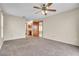 Spacious carpeted bedroom with private bathroom, a ceiling fan, and natural light at 117 Honeywood Dr, Kissimmee, FL 34743