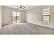 Large main bedroom featuring a ceiling fan, private entrance, and ample sunlight at 117 Honeywood Dr, Kissimmee, FL 34743