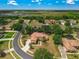 Aerial view of a home on a large lot within a neighborhood with mature trees and landscaping at 12222 Cypress Landing Ave, Clermont, FL 34711