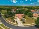 Aerial view of a house with a red tile roof located on a cul-de-sac in a neighborhood at 12222 Cypress Landing Ave, Clermont, FL 34711