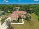 Sprawling home features a tile roof, manicured landscaping, and a circular driveway on a well-kept lot at 12222 Cypress Landing Ave, Clermont, FL 34711