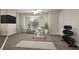 This exercise room boasts an exercise bike, treadmill, and weights at 12222 Cypress Landing Ave, Clermont, FL 34711
