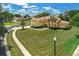 Expansive lawn and mature trees surround this charming two-story home on a large corner lot at 12222 Cypress Landing Ave, Clermont, FL 34711