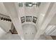 Open foyer with vaulted ceiling, tiled floors, and stair access to the second level at 12222 Cypress Landing Ave, Clermont, FL 34711