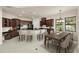 Open concept kitchen with dark wood cabinetry, a breakfast bar, and a dining area at 12222 Cypress Landing Ave, Clermont, FL 34711