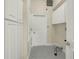 Well-lit laundry room with white cabinets, tiled floors, and essential hookups at 12222 Cypress Landing Ave, Clermont, FL 34711