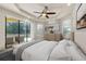 Serene main bedroom with tray ceilings, neutral tones, and a view of the backyard pool at 12222 Cypress Landing Ave, Clermont, FL 34711