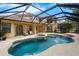 This outdoor pool is surrounded by stone pavers, with an attached spa at 12222 Cypress Landing Ave, Clermont, FL 34711
