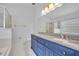 Bathroom features a double sink vanity with granite countertop and a glass-enclosed shower at 131 Calabria Springs Cv, Sanford, FL 32771
