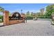 View of the gated entrance with brick signage and paved road leading to the property at 131 Calabria Springs Cv, Sanford, FL 32771