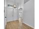 Bright foyer featuring wood-look flooring, chandelier, and arched doorway at 131 Calabria Springs Cv, Sanford, FL 32771