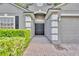 Home exterior featuring a double door, landscaped front yard and architectural details at 131 Calabria Springs Cv, Sanford, FL 32771