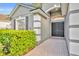 Home exterior featuring a double door, landscaped front yard and architectural details at 131 Calabria Springs Cv, Sanford, FL 32771