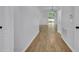 Hallway featuring modern wood-look floors, neutral paint, and natural light at 131 Calabria Springs Cv, Sanford, FL 32771