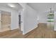 Hallway view showing the updated wood-look floors and bright lighting at 131 Calabria Springs Cv, Sanford, FL 32771