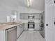 Charming kitchen features gray cabinets, stainless steel appliances and light countertops at 131 Calabria Springs Cv, Sanford, FL 32771