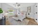 Bright main bedroom features modern decor, a ceiling fan, and natural light at 131 Calabria Springs Cv, Sanford, FL 32771