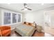 Bright bedroom features natural light from large windows, dark wood floors, a ceiling fan, and modern decor at 14 N Lawsona Blvd, Orlando, FL 32801