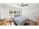 Bright bedroom boasts a large window, providing lots of natural light, ceiling fan, closet and dark wood floors at 14 N Lawsona Blvd, Orlando, FL 32801