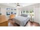 Bright bedroom features large windows providing ample natural light, a ceiling fan, and dark wood floors at 14 N Lawsona Blvd, Orlando, FL 32801