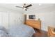 Bedroom features closet, dark wood floors, dresser, TV, ceiling fan, and paneling at 14 N Lawsona Blvd, Orlando, FL 32801