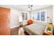 This charming bedroom features dark wood floors, a ceiling fan, and lots of natural light with large windows at 14 N Lawsona Blvd, Orlando, FL 32801