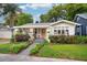 Inviting home exterior with vibrant flowerbeds, sidewalk, and colorful front door at 14 N Lawsona Blvd, Orlando, FL 32801