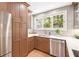 Well-lit kitchen boasting stainless steel appliances, custom wood cabinets, quartz counters, and designer backsplash at 14 N Lawsona Blvd, Orlando, FL 32801