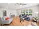 Sunlit living room featuring hardwood floors, neutral furniture, and large windows at 14 N Lawsona Blvd, Orlando, FL 32801