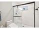 Modern shower features white subway tile, dark trim, bidet toilet seat and is well-lit and clean at 14 N Lawsona Blvd, Orlando, FL 32801