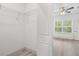 Spacious walk-in closet with built in wire shelving and wood flooring next to a bedroom at 14294 Sw 33Rd Court Rd, Ocala, FL 34473