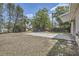 A shot of the backyard with a large area of grass and trees at 1602 Sheffield Rd, Leesburg, FL 34748
