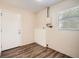 This basement has laminate flooring and a white door at 1602 Sheffield Rd, Leesburg, FL 34748